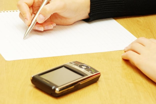 A hand filling out an unemployment benefits application form, with various supporting documents placed nearby. The setting includes a calendar and a pen.