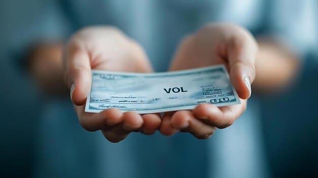 A close-up of a hand holding an uncashed check with 