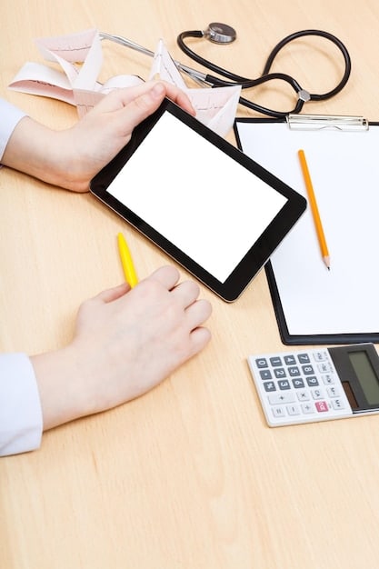 A close-up of a hand pointing at different health plan options on a tablet screen, with a focus on comparing costs and benefits.