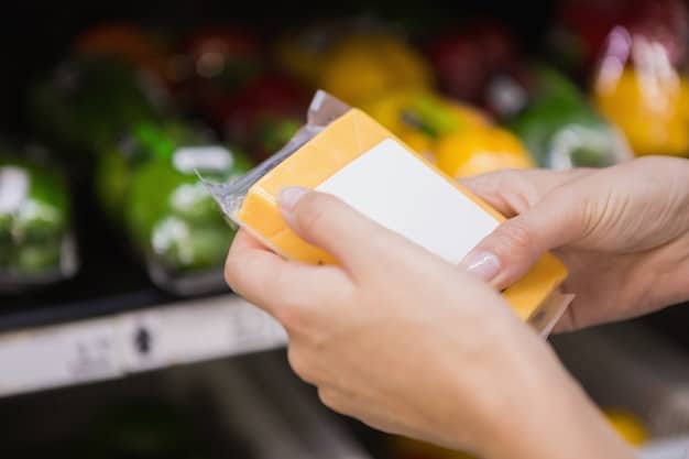 A hand holding a SNAP card while shopping for groceries at a supermarket. The image emphasizes the food and nutrition assistance provided by government programs.