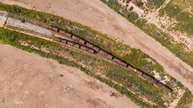 An aerial view of a construction site for a new high-speed rail line in a rural area, showcasing transportation infrastructure development.