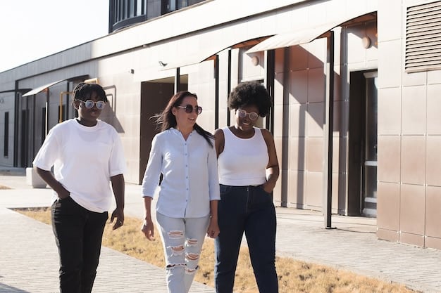 A diverse group of people standing in front of a construction site with new homes being built, showcasing the positive impact of the program.