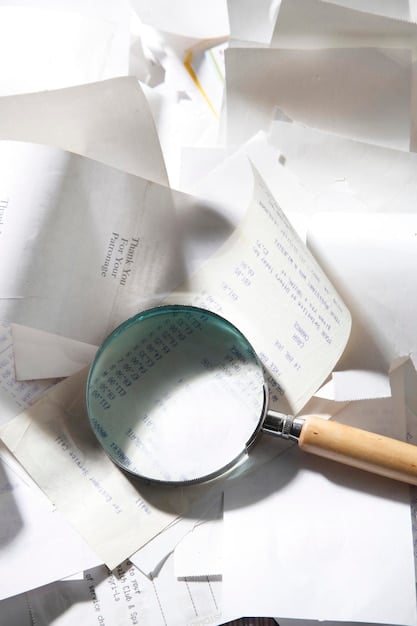 A magnifying glass focusing on a line of a tax document, symbolizing the careful review necessary to avoid errors and potential audits.