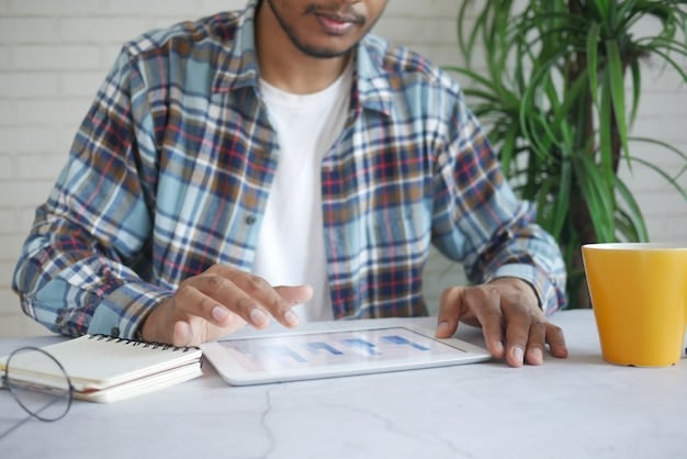 A person using a tablet to access their FGTS account, with charts and graphs visualizing potential financial gains from participating in the Saque-Aniversário program. The setting is a comfortable home environment.