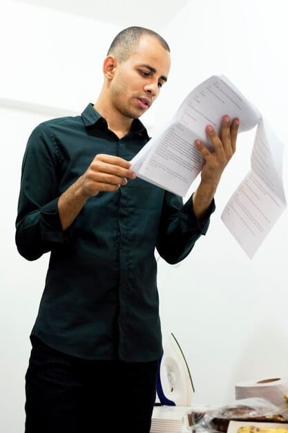 A man reviews a checklist of documents required for obtaining a Brazilian reservist certificate, emphasizing the importance of having all necessary paperwork ready. The atmosphere should be organized and detail-oriented.
