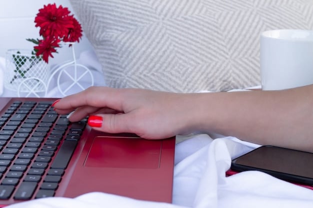Close-up of hands typing on a laptop keyboard, focusing on the eSocial Doméstico website interface with clear fields for employee registration and salary information, emphasizing ease of use and accessibility.