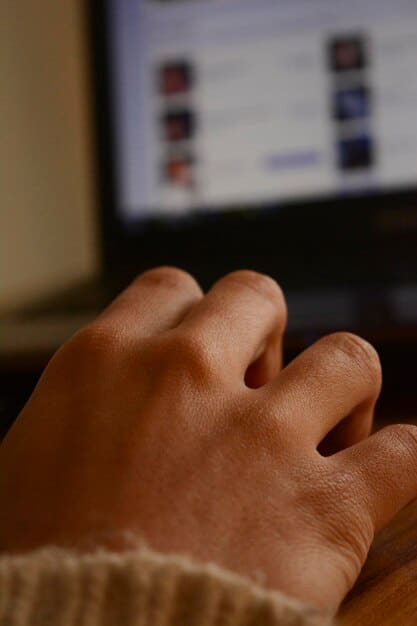 A close-up shot of a person's hands filling out an online form on the Portal do Empreendedor website, with a focus on the sections asking for business activity and address details.