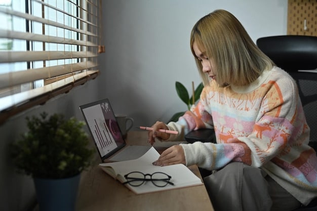 A person looking at a laptop screen with graphs and charts, wearing glasses, with a pen in hand as if analyzing data. The setting is a home office, suggesting remote work.