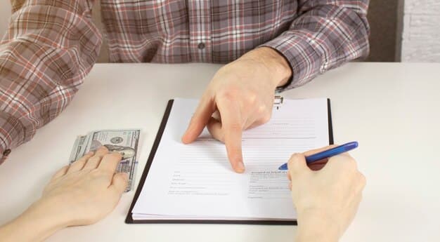 A close-up of an individual's hands carefully filling out an income tax form, with a calculator and various financial documents scattered on the desk. The scene highlights the meticulous nature of tax preparation.