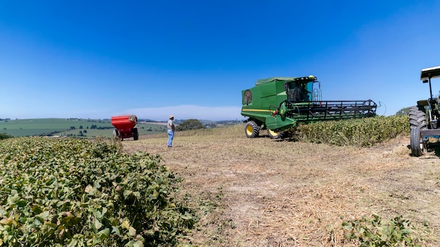 A vast soybean plantation in Brazil, with tractors harvesting the crop, showing the scale of agribusiness.