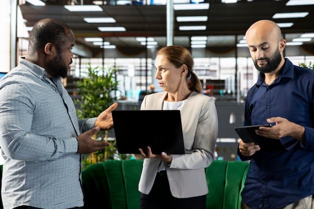A group of diverse workers in a modern office setting, collaboratively working on laptops and discussing projects. The scene conveys innovation and technological advancement in the service sector.