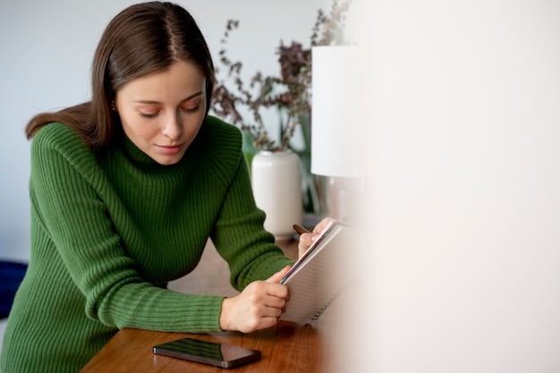 A person writing in a journal, reflecting on their spending habits and financial goals.
