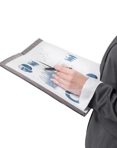 A close-up of a hand holding a magnifying glass over a document with financial charts and graphs, emphasizing the importance of detailed analysis and precision.