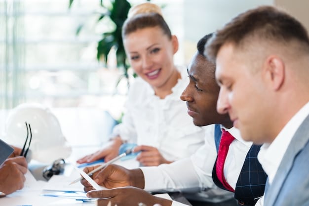 A panoramic shot of a diverse group of people collaborating around a table with financial documents, showcasing a team working together on financial planning and investment strategies to navigate the complexities of tax reforms.